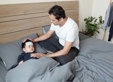Father taking care of sick kid